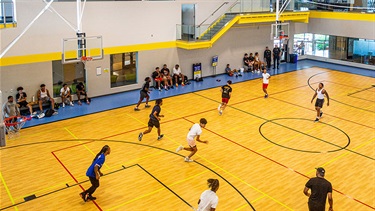 Teens playing basketball in gym