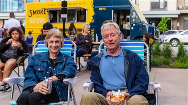 Couple watching the band performing at Friday Night Sound Bites
