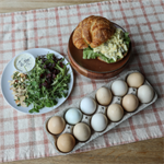 Egg salad on fresh croissant and Kansas harvest salad made by Homestead Kitchen + Bakery